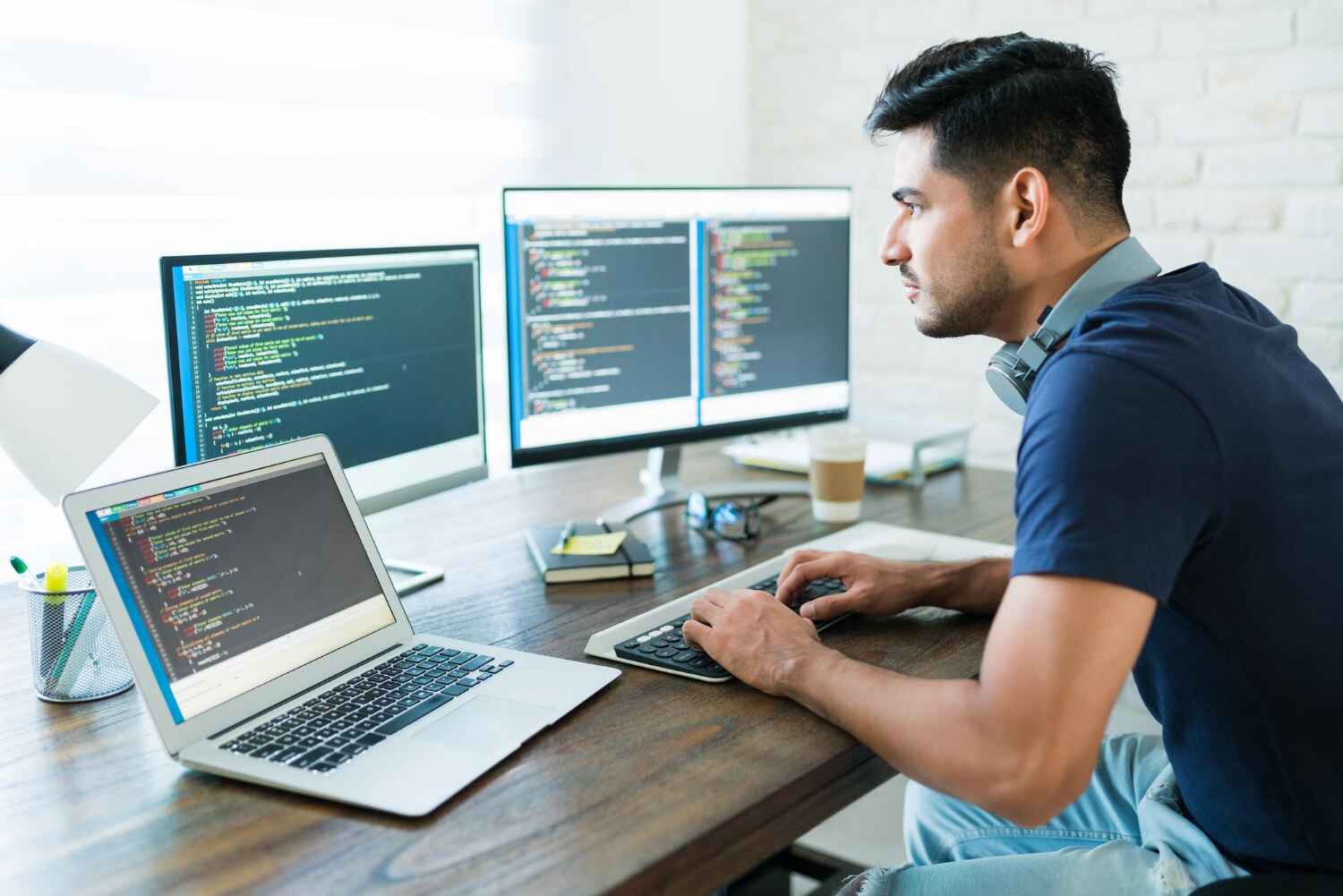 side view attractive hispanic software developer programming using computer while working from home 1